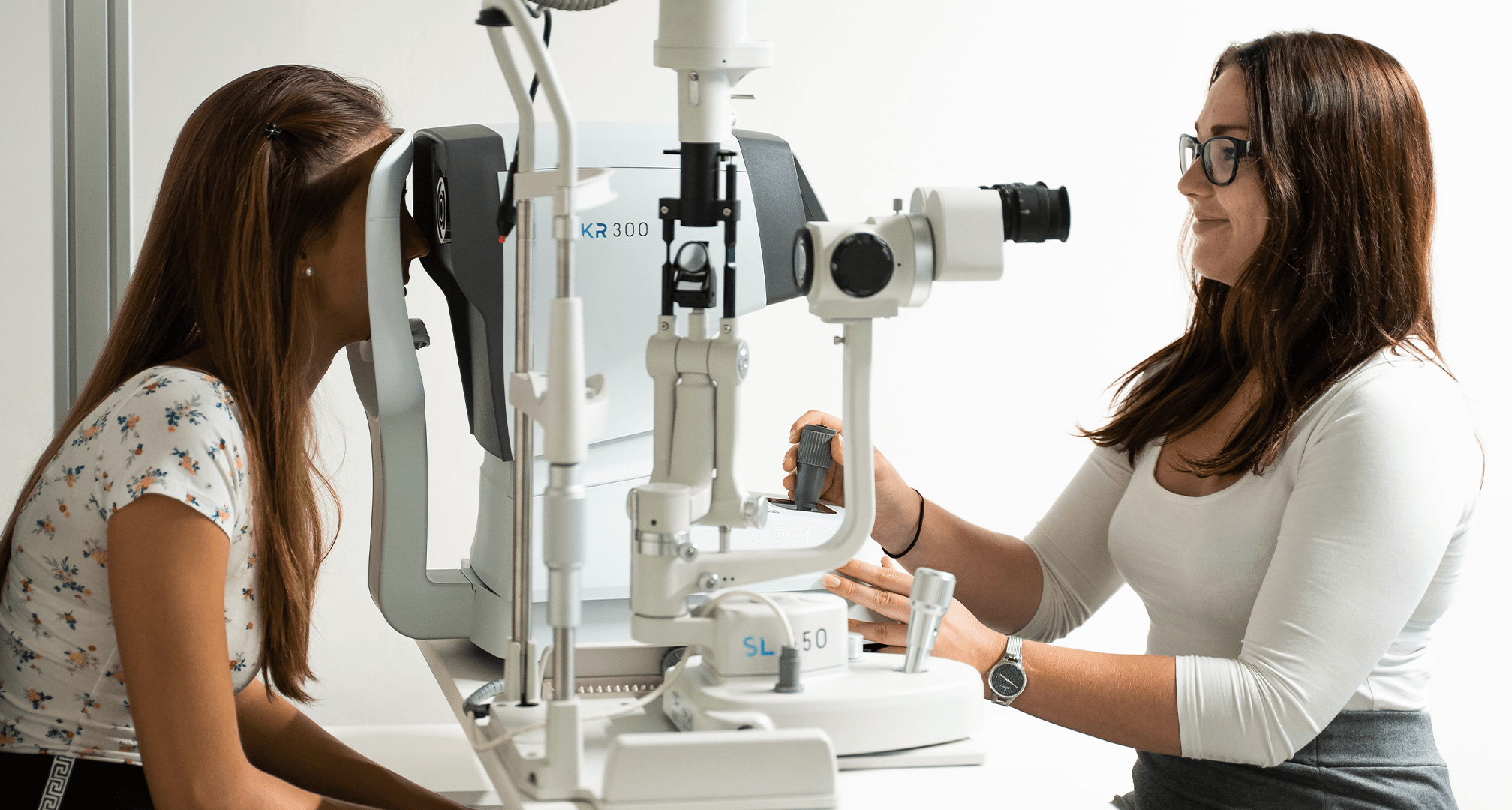 optometrist performing eye exam on patient